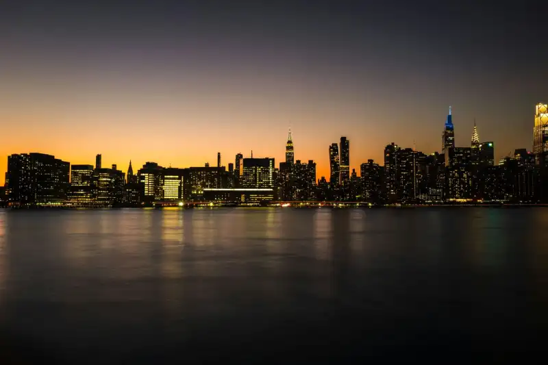 The Manhattan skyline at dusk, lit across the water